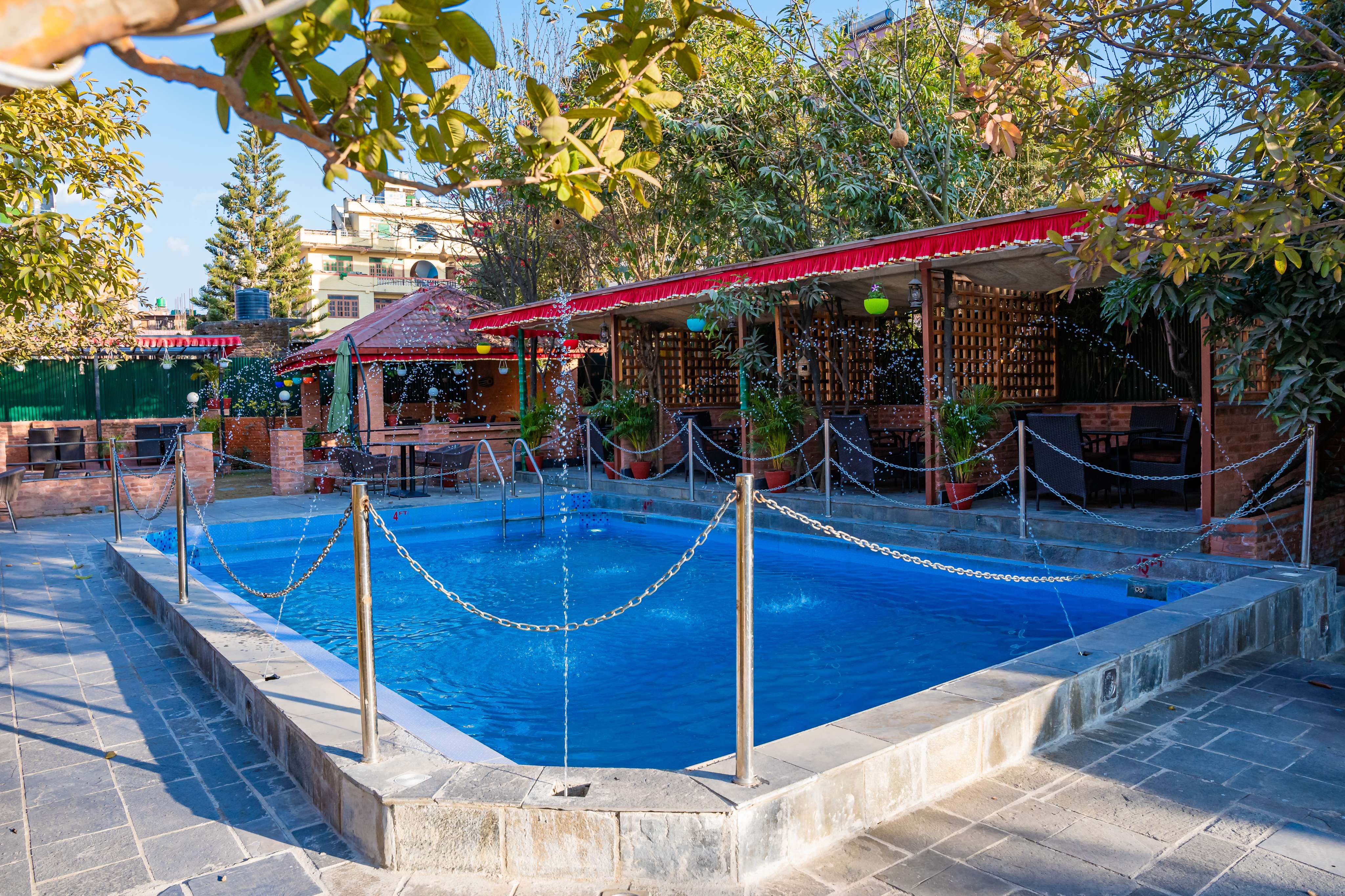 Outdoor swimming pool at Hotel Yechu in Bhaktapur, offering a calm space for guests to relax after exploring nearby heritage sites.