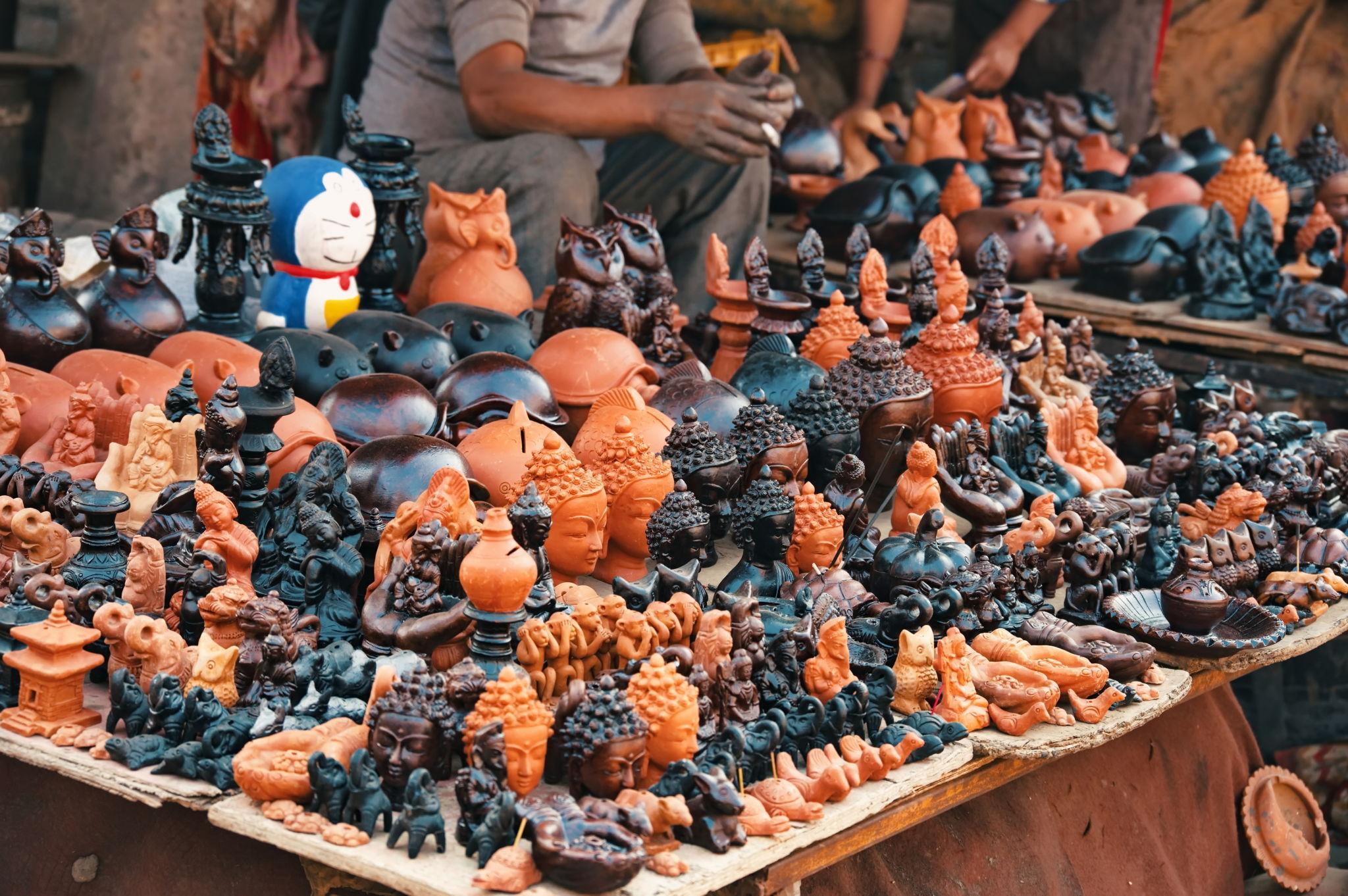 Local artisans shaping clay pots at Pottery Square in Bhaktapur using traditional Newar pottery techniques.